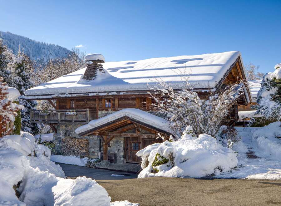 This stunning chalet, nestled in a winter wonderland, offers a perfect blend of rustic charm and modern comfort.