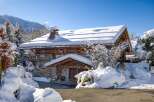 This stunning chalet, nestled in a winter wonderland, offers a perfect blend of rustic charm and modern comfort.