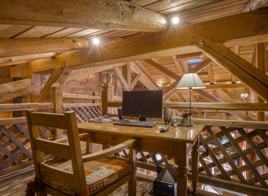 Experience rustic charm in this unique property, featuring a cozy home office nestled within a stunning wooden structure.