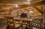 Experience rustic charm in this unique property, featuring a cozy home office nestled within a stunning wooden structure.