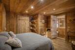This cozy bedroom features a rustic, wooden design, creating a warm and inviting atmosphere.