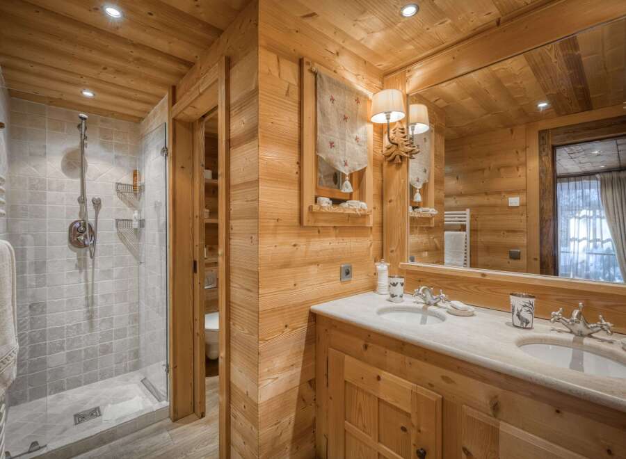 This stunning bathroom showcases a rustic design with warm wooden accents throughout.