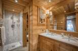 This stunning bathroom showcases a rustic design with warm wooden accents throughout.