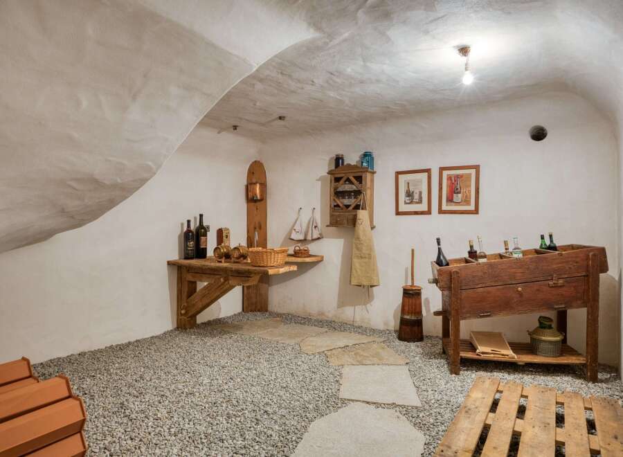 Step into this charming wine cellar, a perfect space for storing and enjoying your favorite vintages.