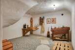 Step into this charming wine cellar, a perfect space for storing and enjoying your favorite vintages.