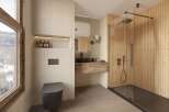 Experience luxury in this stunning bathroom, featuring a sleek black toilet and a modern shower with glass doors.