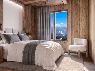 Experience the ultimate mountain retreat in this cozy bedroom, featuring rustic wood paneling and a plush bed perfect for unwinding after a day on the slopes.
