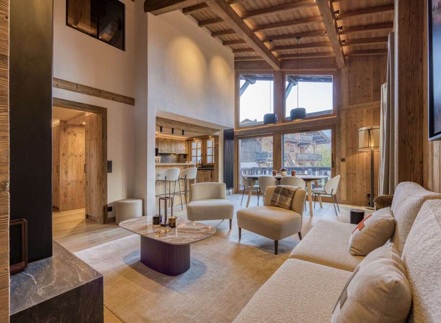 Experience luxury living in this stunning chalet, featuring a warm and inviting interior with wooden accents throughout.