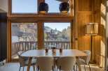 Experience the charm of this stunning property, featuring a beautifully designed dining area with a wooden table and stylish chairs.
