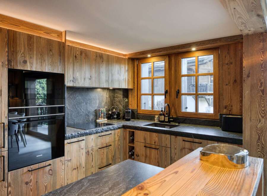 This stunning kitchen showcases a rustic yet modern design, perfect for a luxury home.