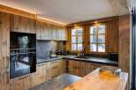 This stunning kitchen showcases a rustic yet modern design, perfect for a luxury home.