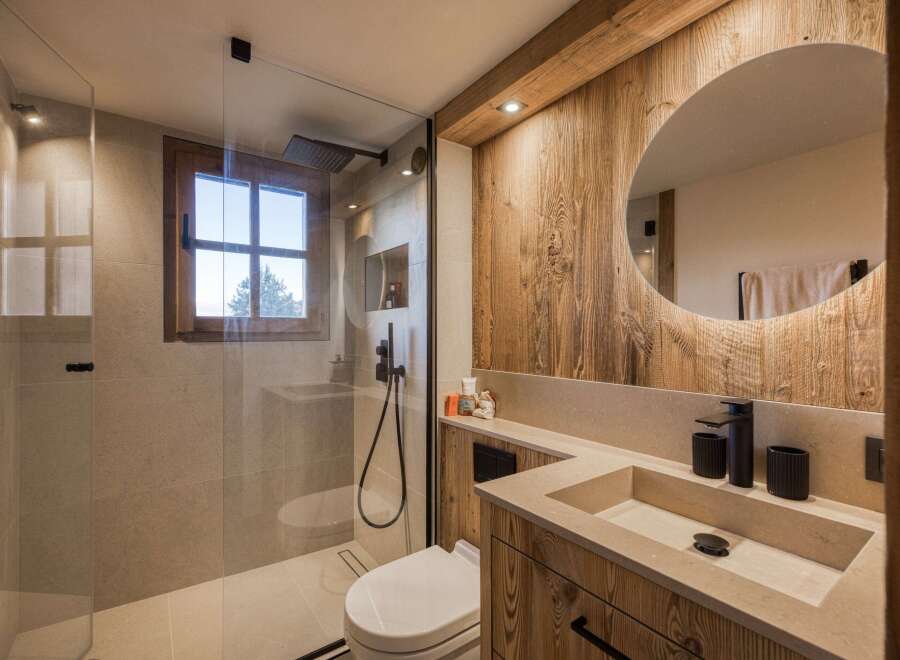 Experience luxury in this stunning bathroom featuring a modern design and rustic wood accents.