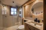 Experience luxury in this stunning bathroom featuring a modern design and rustic wood accents.