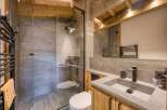 This stunning bathroom boasts a modern design with rustic elements, creating a luxurious and inviting space.