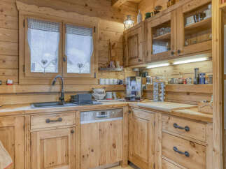 This charming kitchen boasts a rustic, inviting atmosphere with its warm wooden cabinetry and countertops.