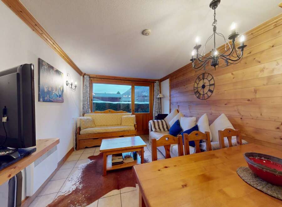 This cozy living space features a warm wooden interior, creating a welcoming atmosphere.