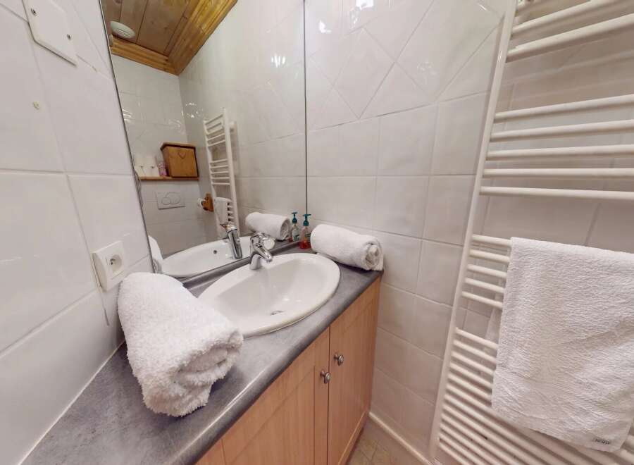 This charming bathroom features a bright and airy design, perfect for starting your day.
