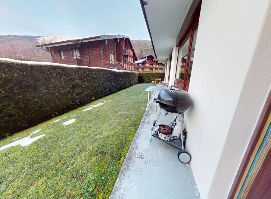 Enjoy the tranquility of this charming property, featuring a lush green lawn and a well-maintained hedge.