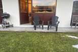 Enjoy outdoor living with this charming property, featuring a cozy patio and lush green lawn.