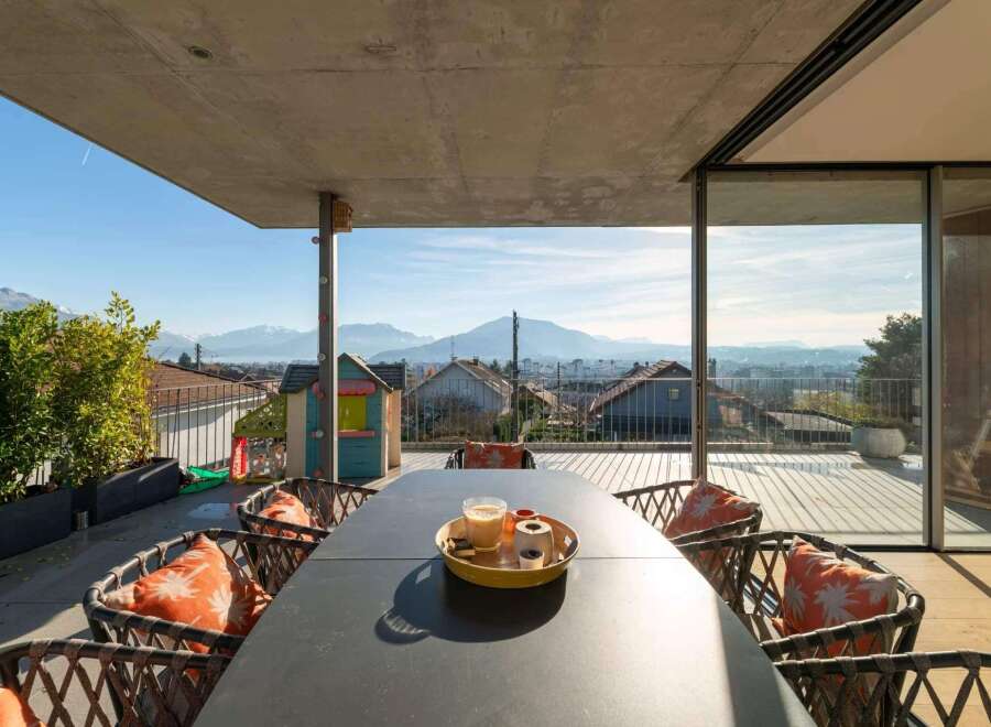 Enjoy breathtaking views from this stunning property! This outdoor space features a modern design with a spacious dining area, perfect for entertaining.