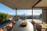 Enjoy breathtaking views from this stunning property! This outdoor space features a modern design with a spacious dining area, perfect for entertaining.