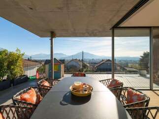 Enjoy breathtaking views from this stunning property! This outdoor space features a modern design with a spacious dining area, perfect for entertaining.