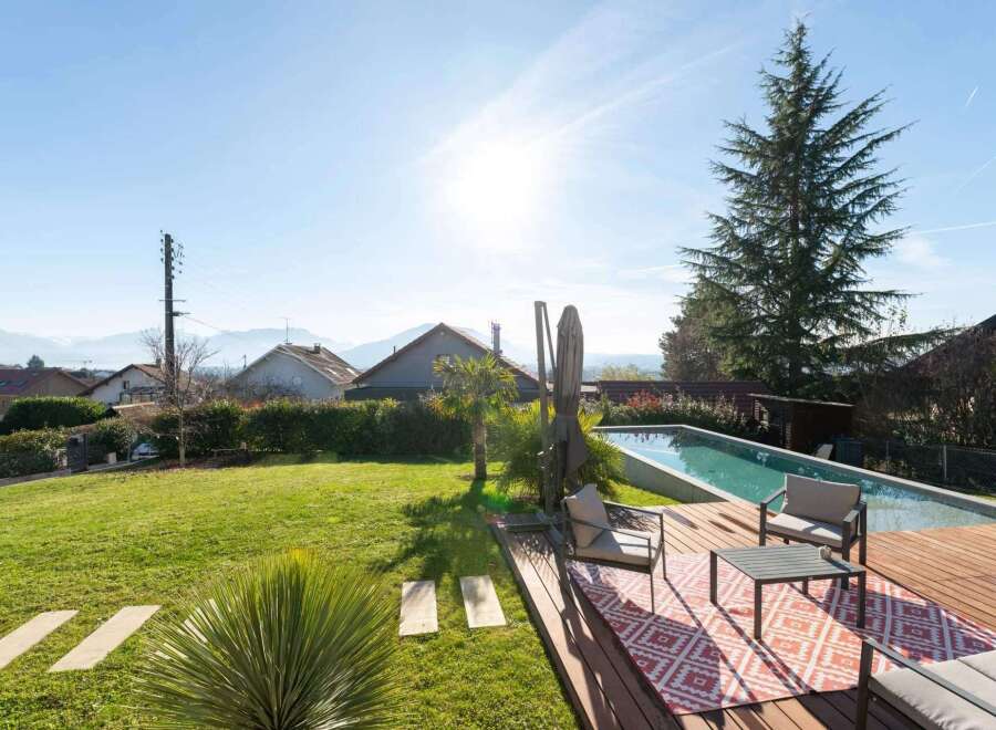 Enjoy the ultimate outdoor living experience with this stunning property featuring a pristine swimming pool and a spacious wooden deck, perfect for relaxation and entertaining.