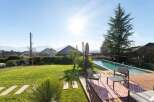 Enjoy the ultimate outdoor living experience with this stunning property featuring a pristine swimming pool and a spacious wooden deck, perfect for relaxation and entertaining.