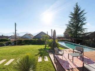 Enjoy the ultimate outdoor living experience with this stunning property featuring a pristine swimming pool and a spacious wooden deck, perfect for relaxation and entertaining.