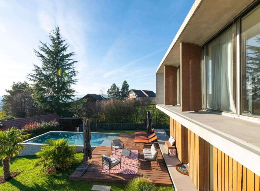 Experience luxury living in this stunning property with a private pool and expansive outdoor deck.