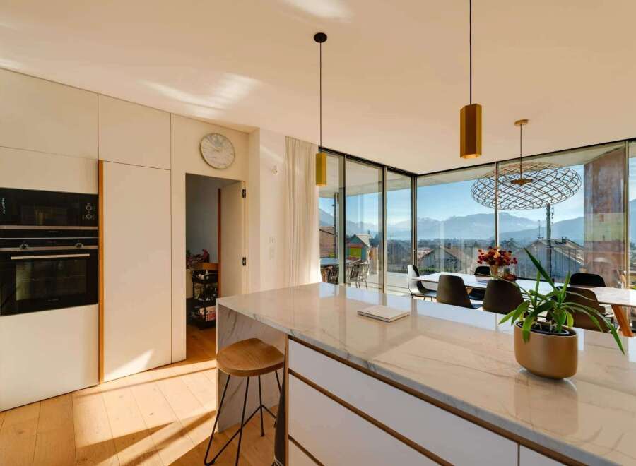 Experience luxury living in this stunning modern kitchen with breathtaking mountain views.
