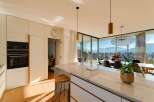 Experience luxury living in this stunning modern kitchen with breathtaking mountain views.
