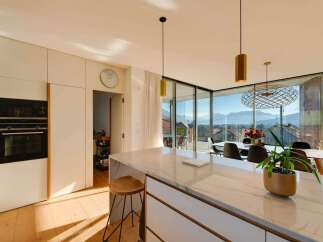 Experience luxury living in this stunning modern kitchen with breathtaking mountain views.