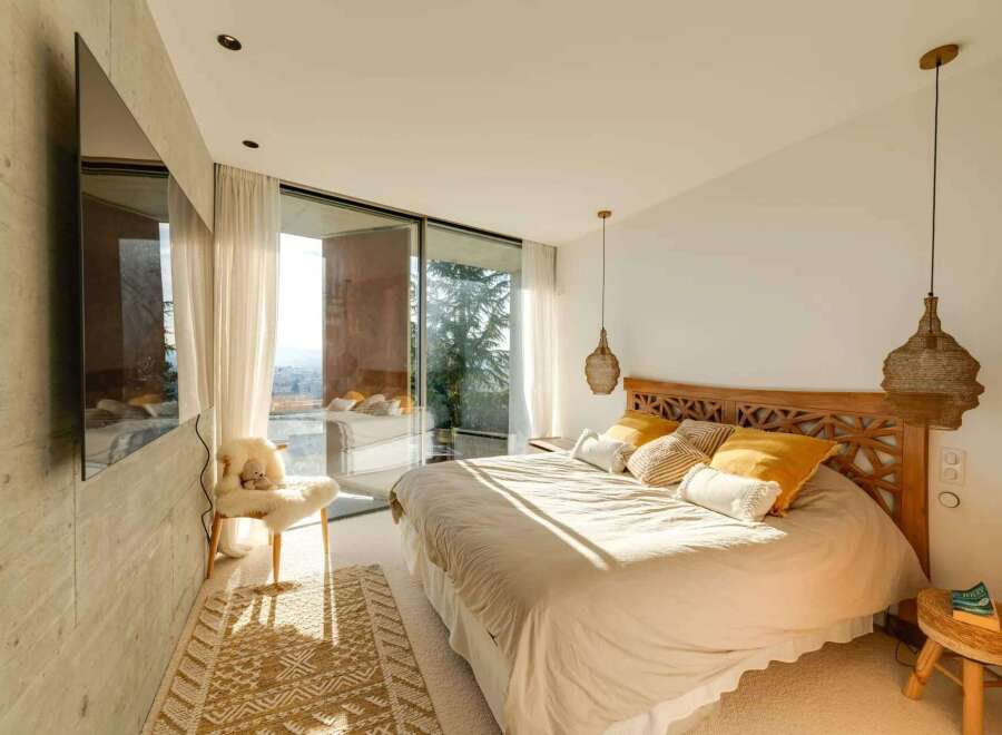 Experience luxury living in this stunning bedroom with breathtaking views.
