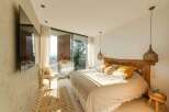 Experience luxury living in this stunning bedroom with breathtaking views.