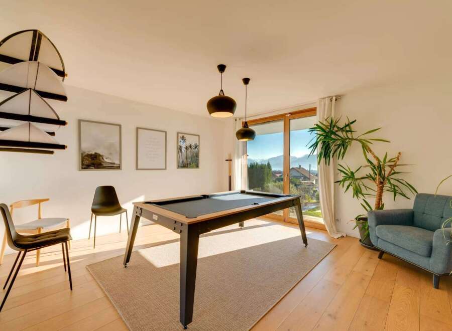 This stunning property boasts a modern interior with a pool table, perfect for entertaining.