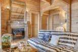 Step into a cozy retreat with this stunning property, featuring a rustic wooden interior that exudes warmth and charm.