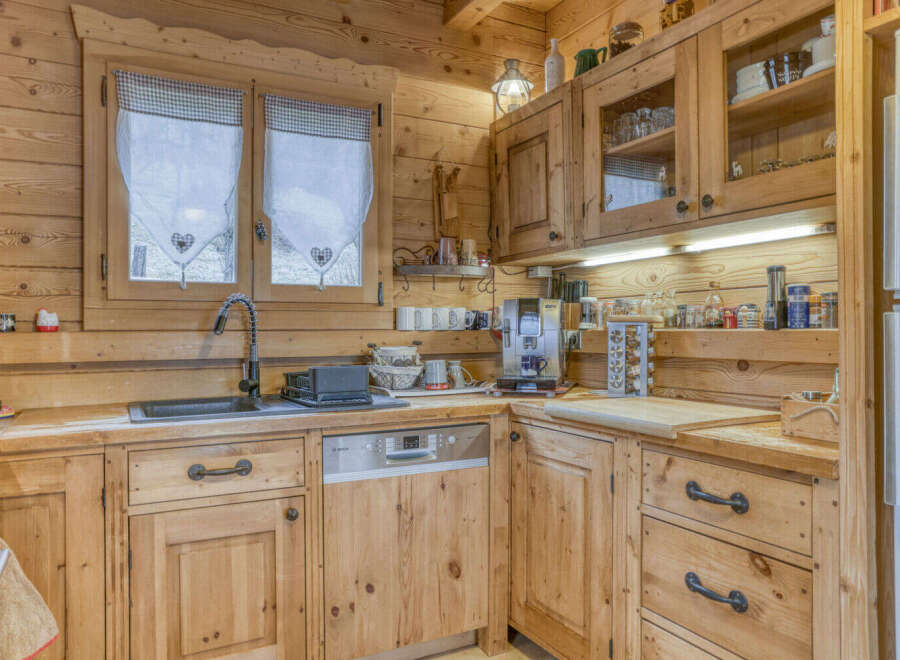 This charming kitchen boasts a rustic, inviting atmosphere with its warm wooden cabinetry and countertops.