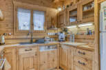 This charming kitchen boasts a rustic, inviting atmosphere with its warm wooden cabinetry and countertops.