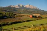 Nestled in a picturesque landscape, this stunning property boasts a charming red barn and expansive green fields.
