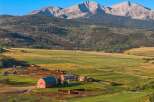 Nestled in a picturesque valley, this stunning property boasts a sprawling ranch with a backdrop of majestic mountains.