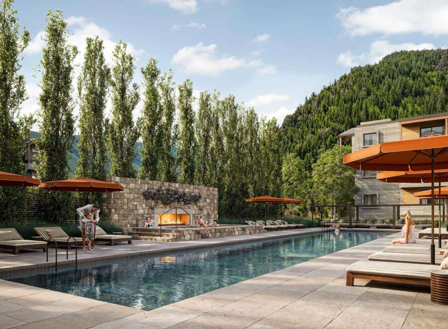 Experience luxury living at this stunning property featuring a beautiful outdoor pool and a cozy fireplace area.