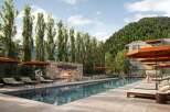 Experience luxury living at this stunning property featuring a beautiful outdoor pool and a cozy fireplace area.