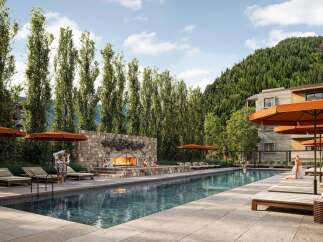 Experience luxury living at this stunning property featuring a beautiful outdoor pool and a cozy fireplace area.