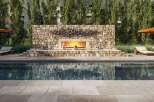 Experience luxury living at its finest with this stunning property featuring a beautiful outdoor pool and a cozy fireplace.