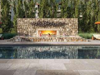 Experience luxury living at its finest with this stunning property featuring a beautiful outdoor pool and a cozy fireplace.