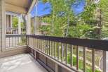 Enjoy the fresh mountain air from this charming balcony, offering serene views of lush greenery and surrounding architecture.