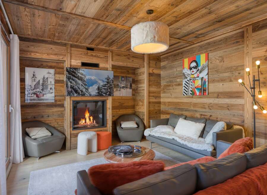 Experience the epitome of luxury living in this stunning property, featuring a cozy living room with a fireplace.