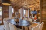 Experience the warmth of this stunning chalet, featuring a cozy fireplace and a rustic wooden interior.