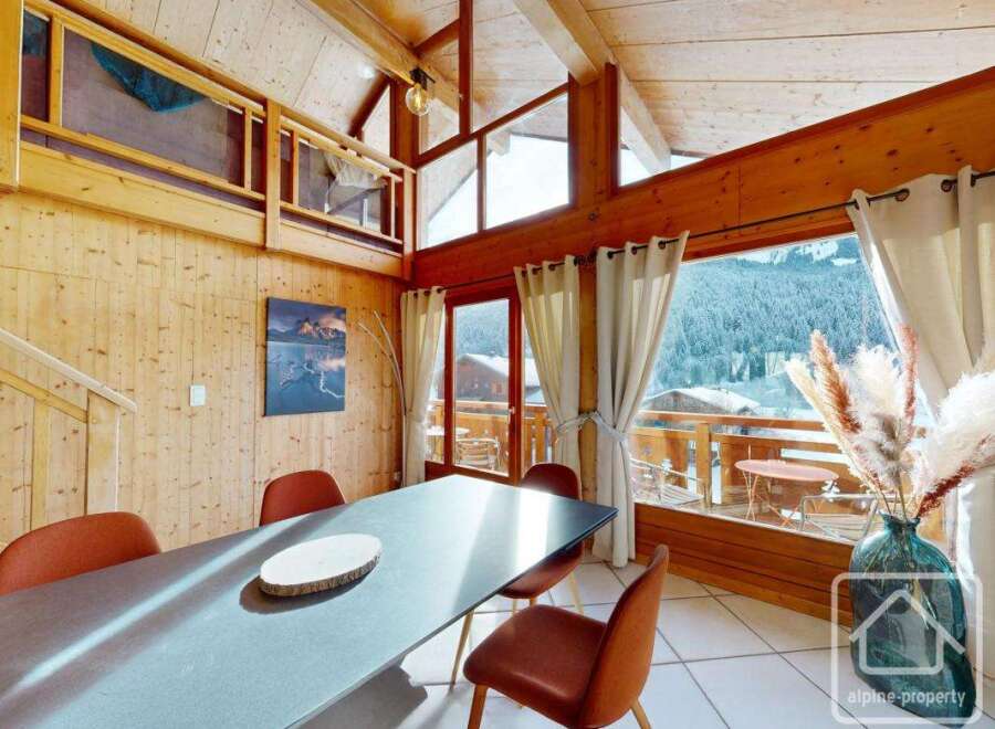 Experience the charm of this stunning property, boasting a spacious dining area with a modern table and stylish chairs.